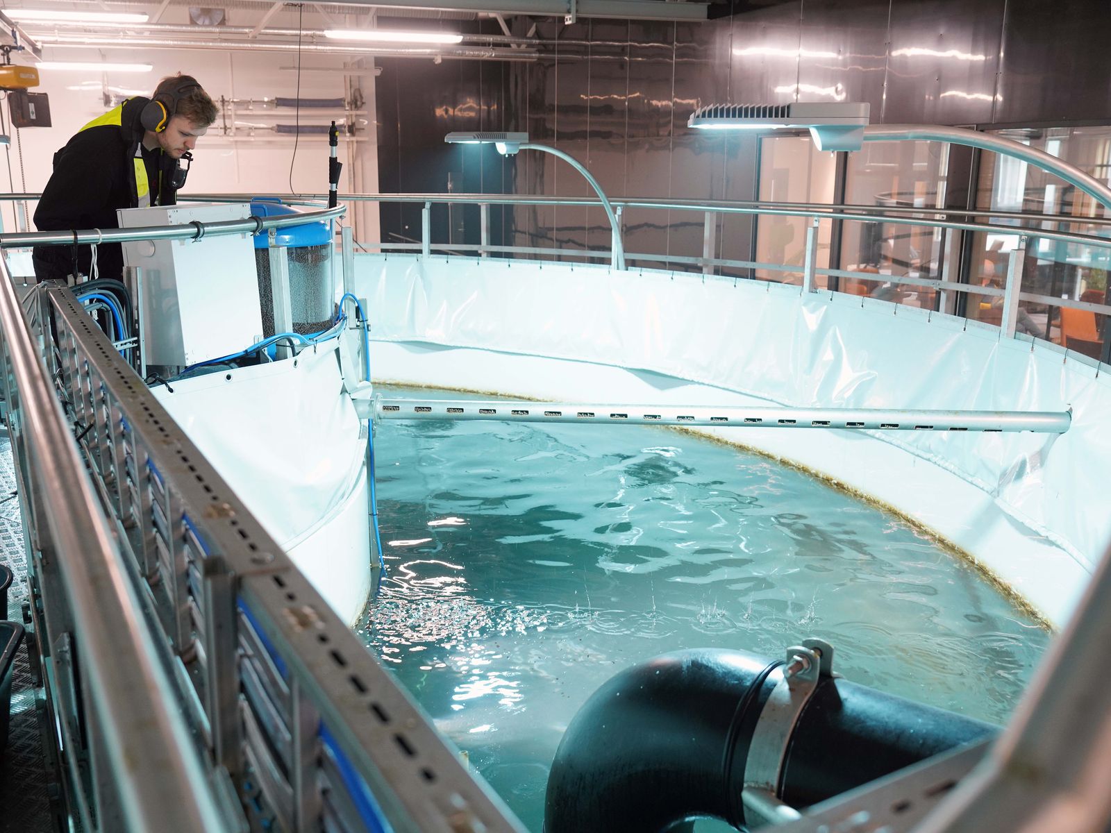 Marius Almenning checking a tank from the walkway in the pilot hall