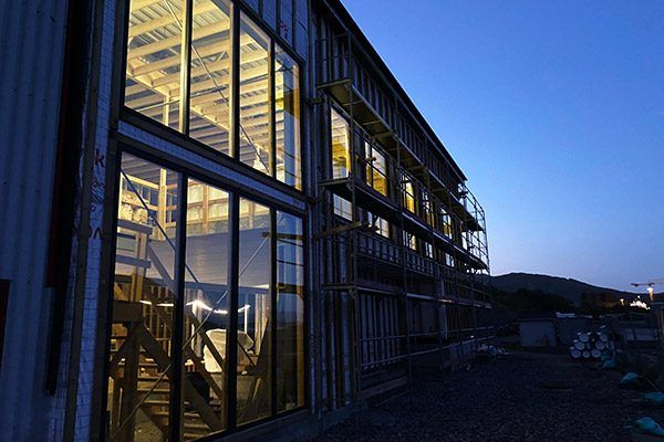 The Måløy facility lit from inside at dusk